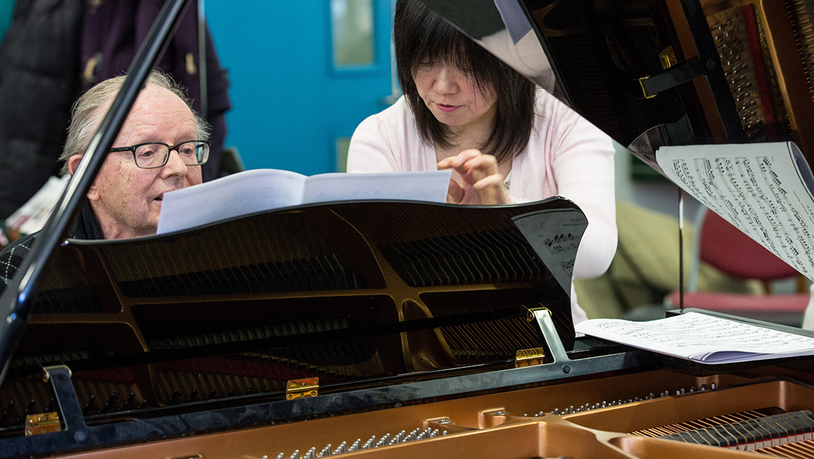 Students at Morley College play the piano.